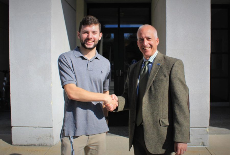 Editor-In-Chief Jack Allsopp (Left) shaking hands with Dean Jonathan Millen (right)
