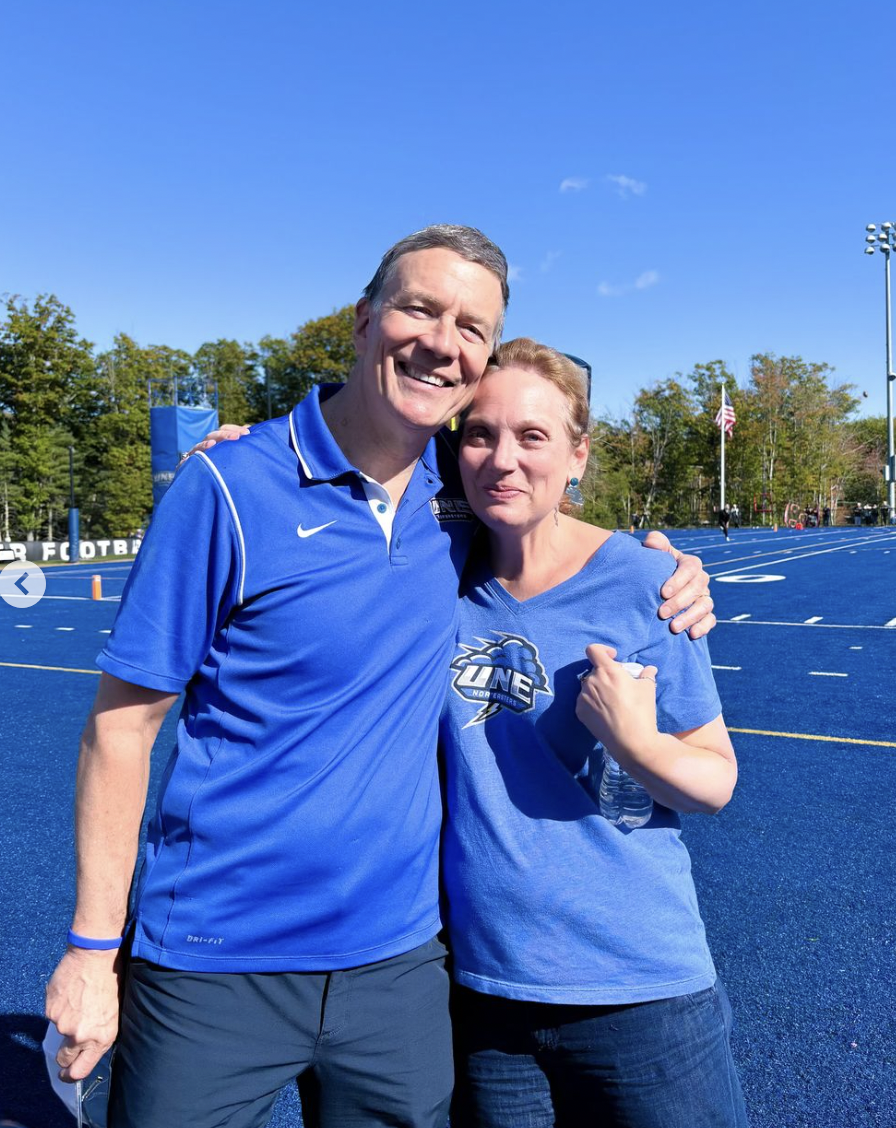 President Herbert and his wife at UNE's 2024 homecoming game.