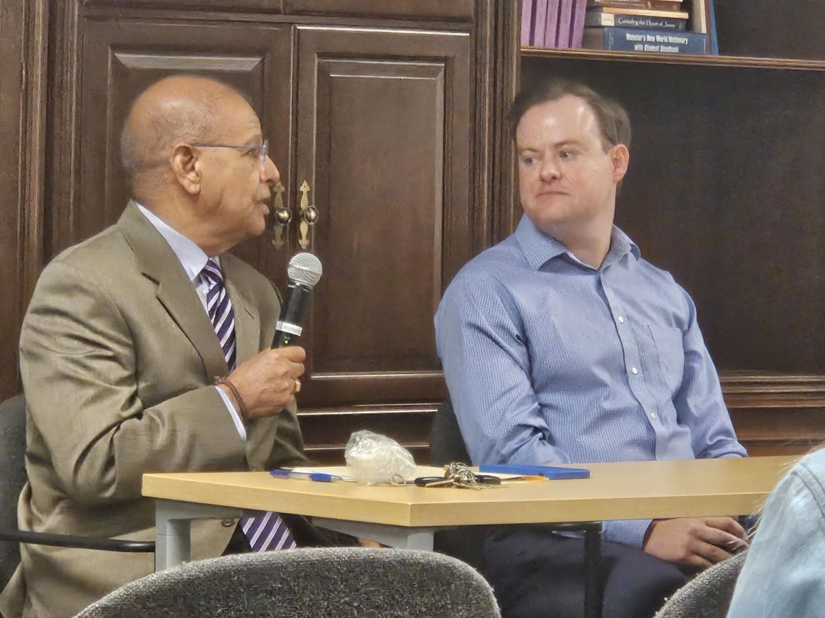 Dr. Ali Ahmida (left) asks Dr. Ryan Williams (right) a question during the post-lecture discussion.